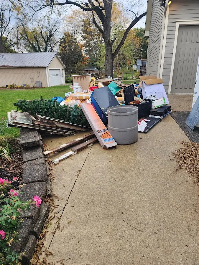 Dumpster being loaded with debris for 3 Yard Dumpster Rental in Mobridge